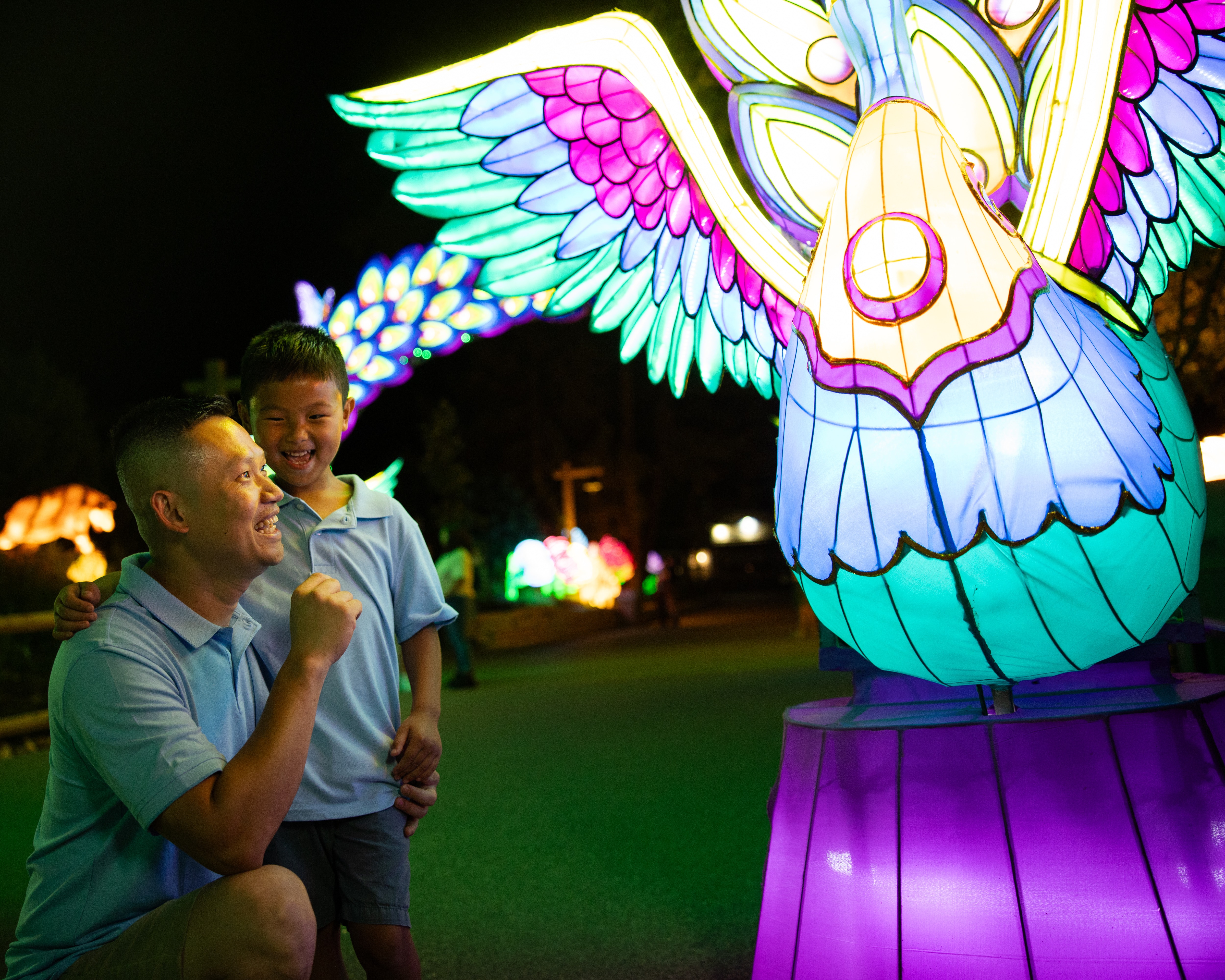 Family looking at colorful lantern and smiling