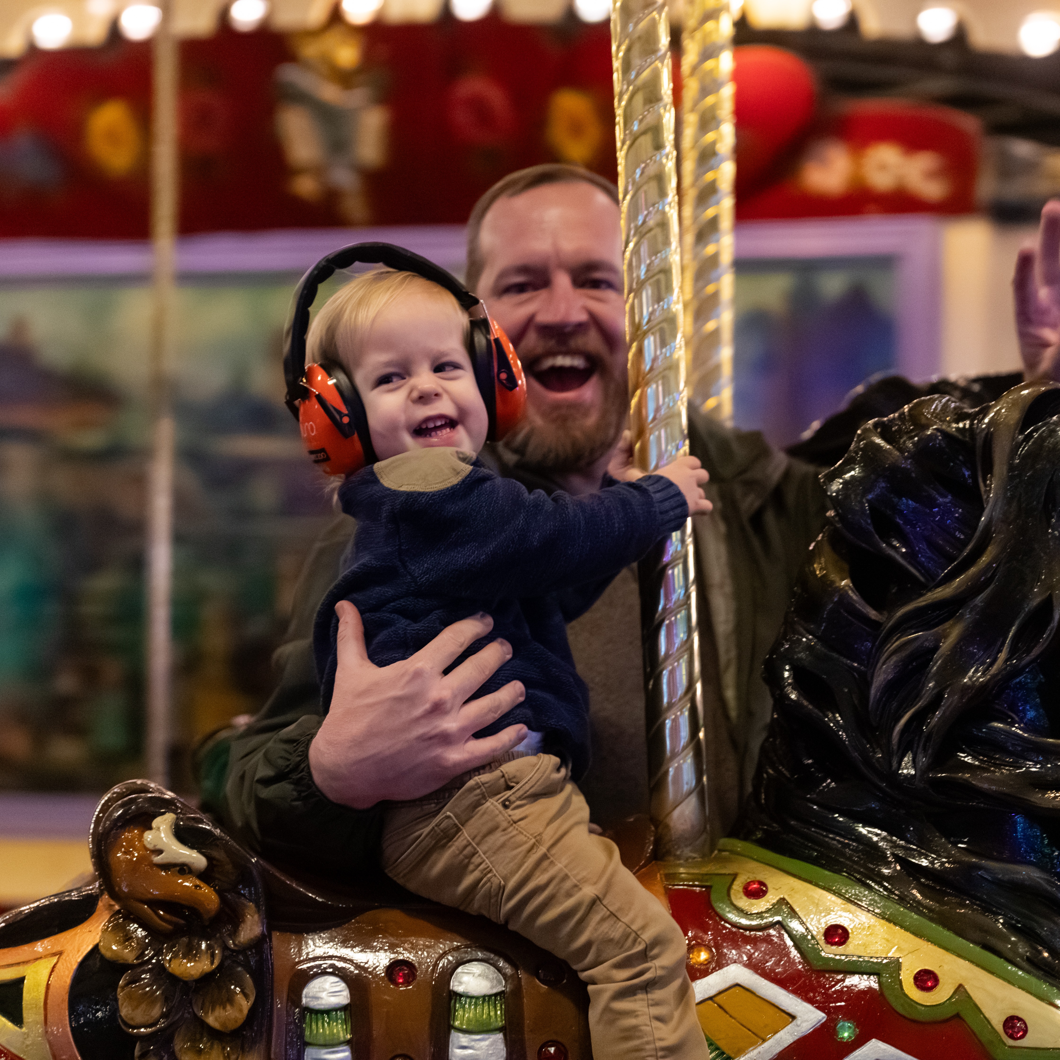 dad and child on carousel