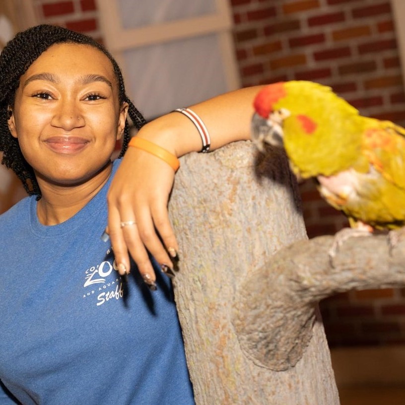 student with bird at zoo