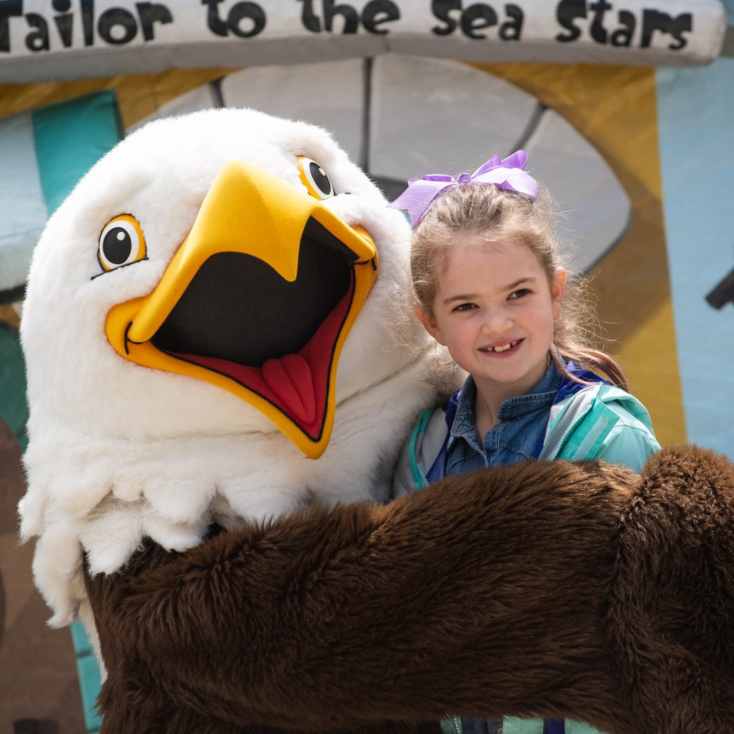 mascot eagle holding child