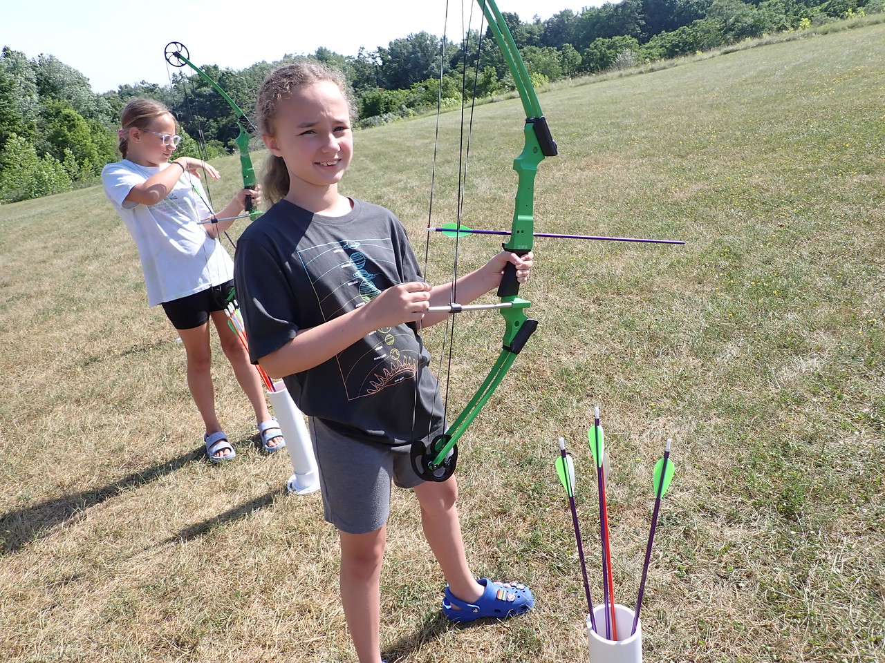 girl holding bow and arrows