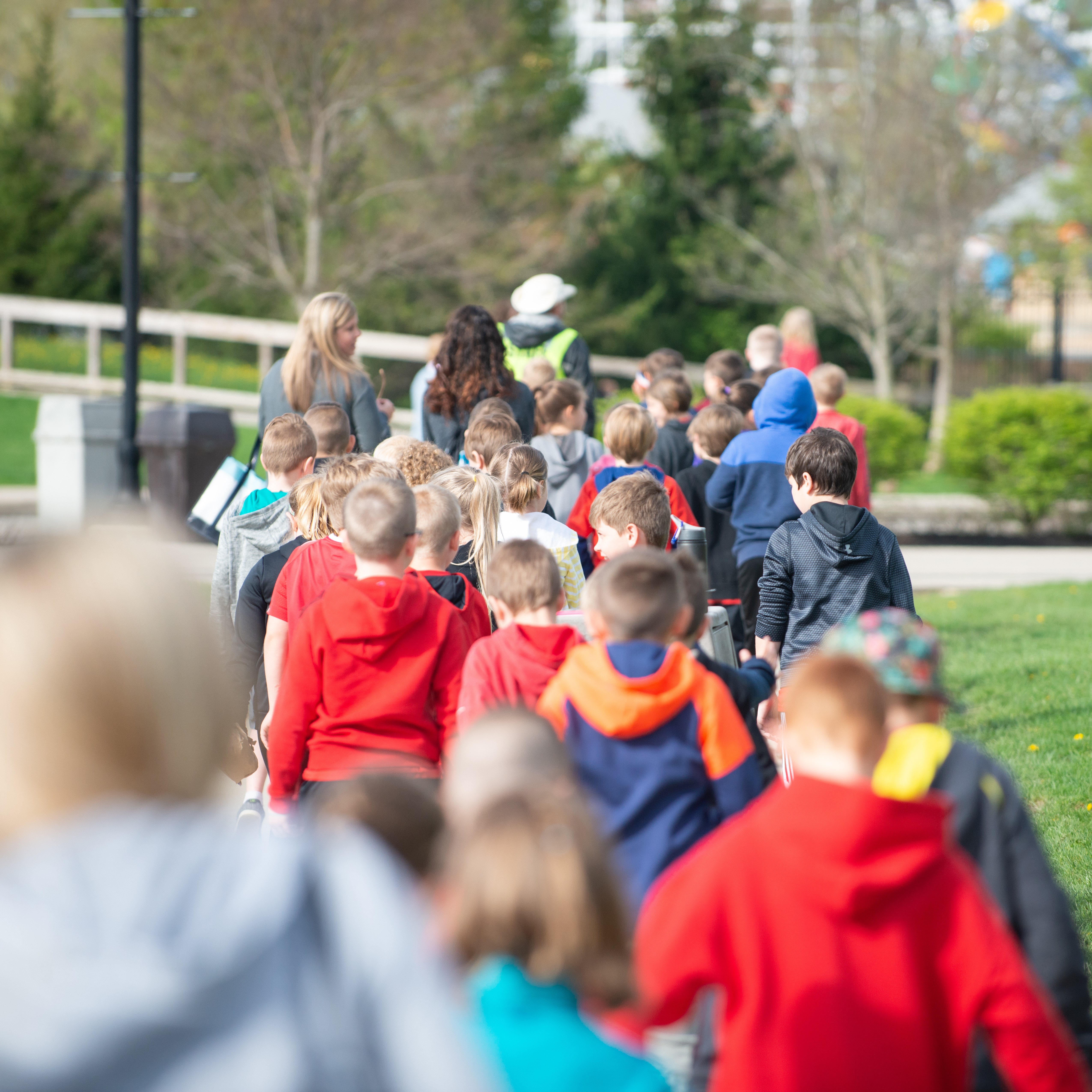 children walking away down sidewalk