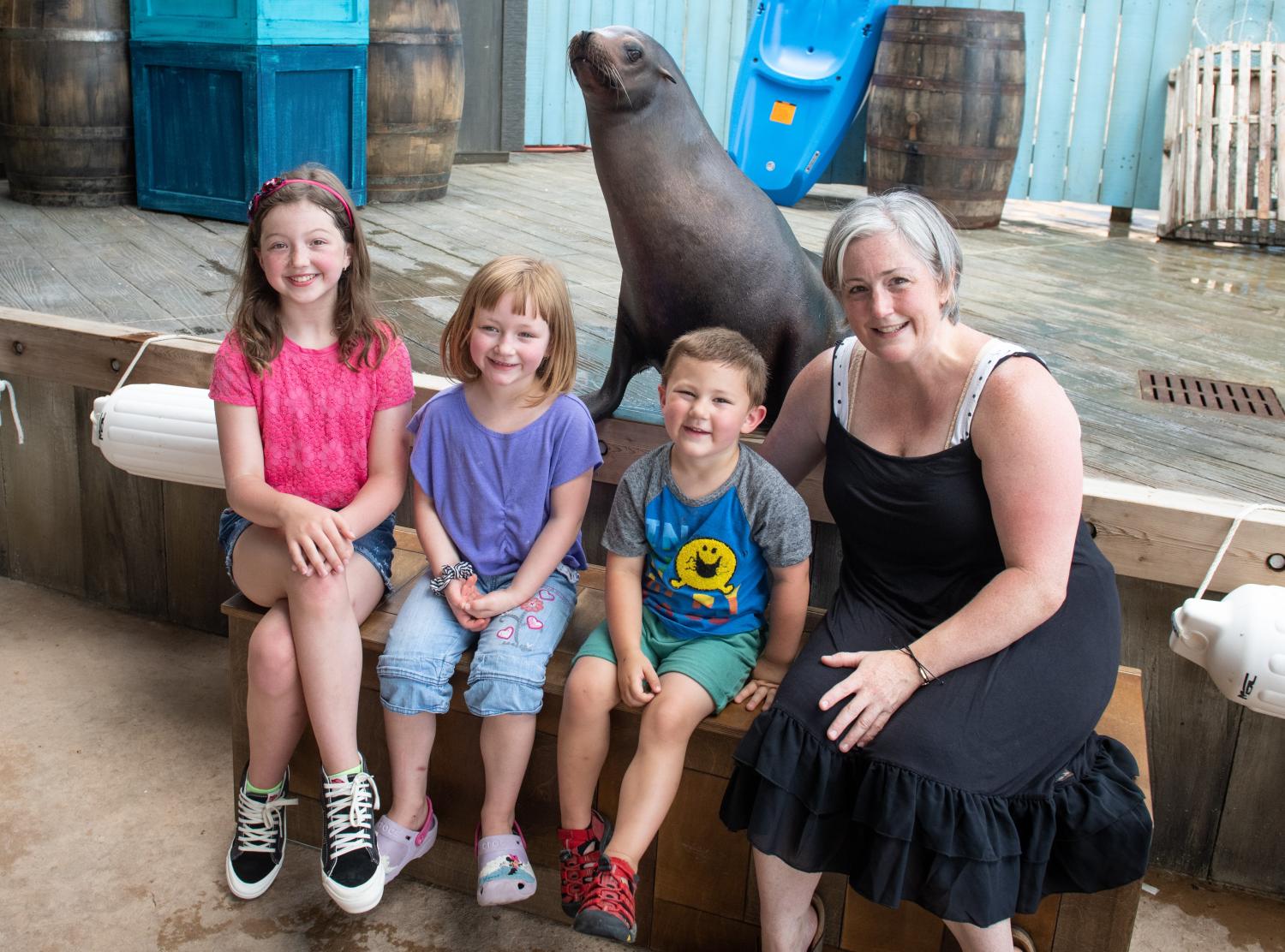 family posing with sea lion