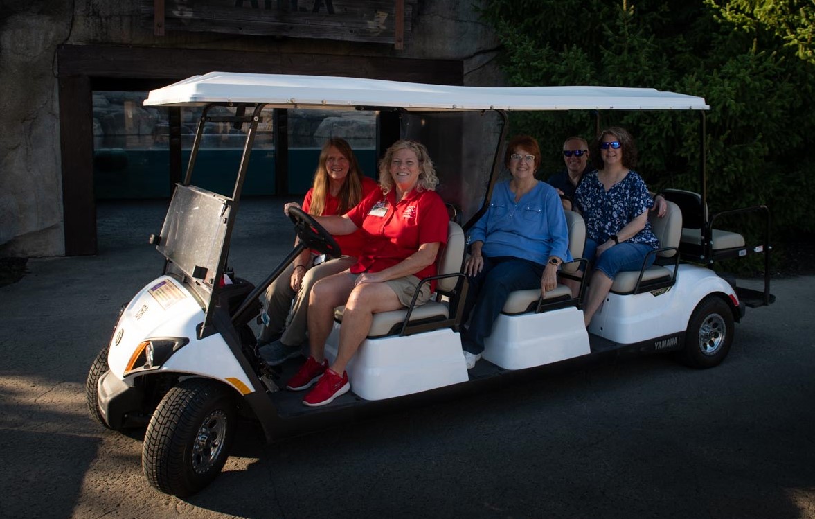 zoo guests on golf cart