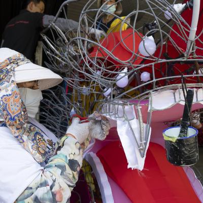 woman painting lantern