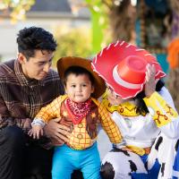 family at a Halloween event, smiling