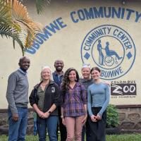 group of people posing in front of building