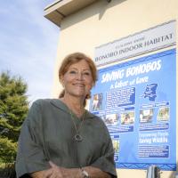 woman posing in front of sign