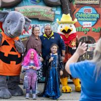 family in costumes and posing for photo