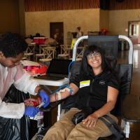 Columbus Zoo team member smiles at camera while donating blood