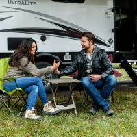 two people sitting in front of RV