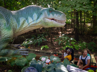 animatronic dinosaur and guests on boat