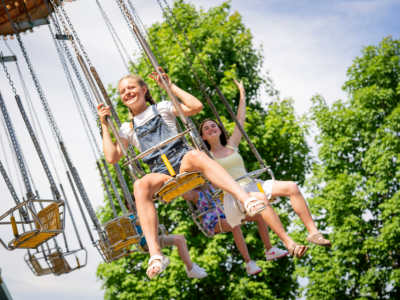 two girls on swing ride at the zoo