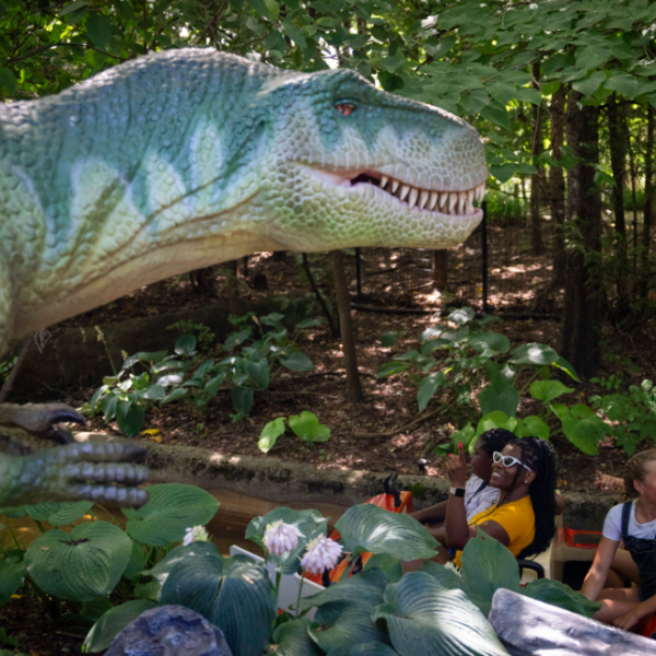 animatronic dinosaur and guests on boat