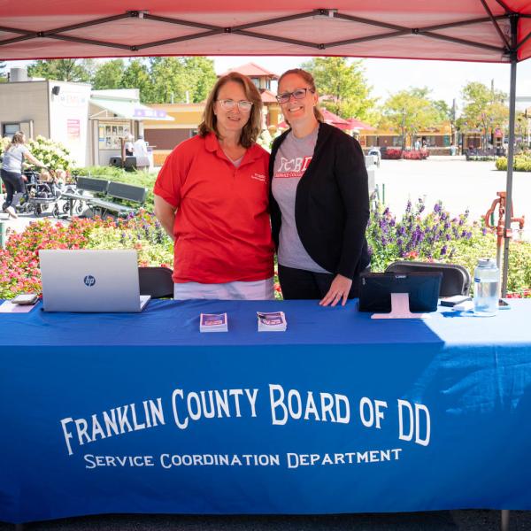 Franklin County Board of DD representatives stand at table to welcome guests