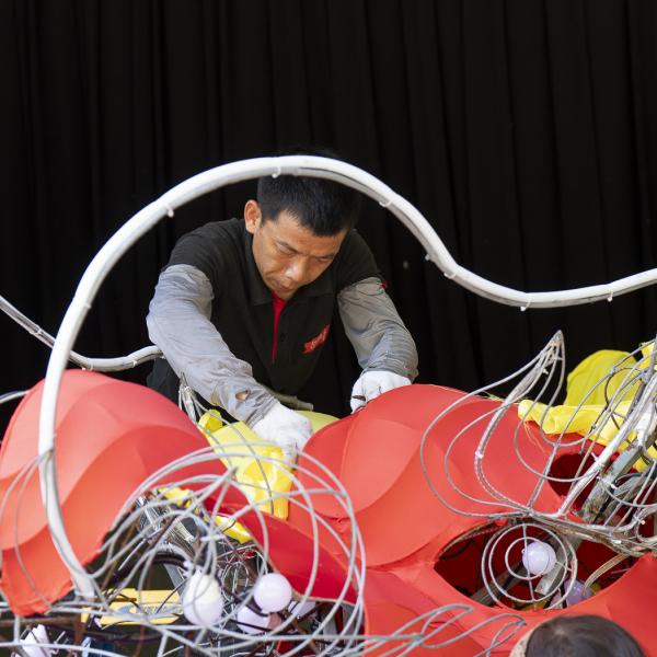 man assembling dragon lantern